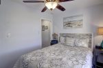 Queen size bed and ceiling fan in the guest bedroom